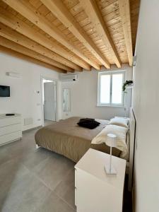 a bedroom with two beds and a television in it at L’Oleandro in Valeggio sul Mincio