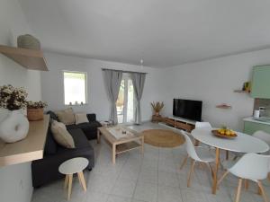 a living room with a couch and a table at Elia Small Paradise in Kos