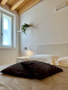 a bedroom with a large pillow on a bed at L’Oleandro in Valeggio sul Mincio