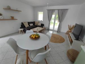 a living room with a white table and chairs at Elia Small Paradise in Kos
