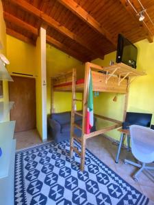 a room with a bunk bed and a desk and a tv at Jenny's Guesthouse! in Artemida