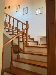 a staircase with wooden railings in a home at Jenny's Guesthouse! in Artemida