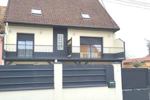 a house with a black fence in front of it at Studio cosy proche Paris Orly in Morangis
