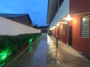 an alley with green lights on the side of a building at Hotel La Villa Morena in Oiapoque