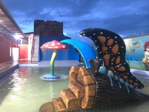 a water park with a butterfly and a mushroom at Hotel La Villa Morena in Oiapoque