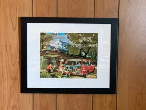 a framed picture of a car on a wall at Scotty's Motel in Munising