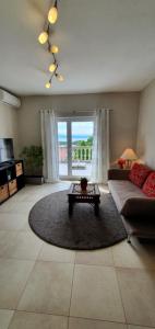 a living room with a couch and a table at Apartments Ruzic Njivice in Njivice