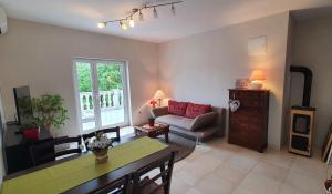 a living room with a couch and a table at Apartments Ruzic Njivice in Njivice
