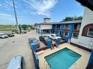 a view of a building with a swimming pool at Airport inn & suites in Corpus Christi