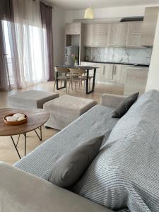 a living room with two beds and a table at Dora's apartment in Dhërmi