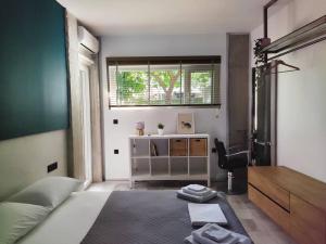 a bedroom with a bed and a desk and a window at Υ27 Modern Design Studio in Mytilini