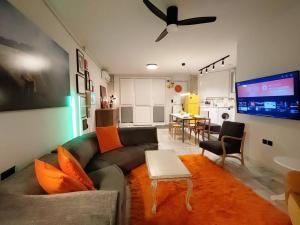 a living room with a couch and a flat screen tv at Υ27 Modern Design Studio in Mytilini