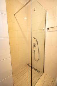 a shower stall with a glass shower door at Valeria Louis perfect getaway - great location Split city center in Split