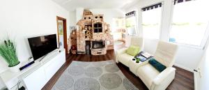 ein Wohnzimmer mit einem Sofa und einem Kamin in der Unterkunft Ferienhaus Grüner Bungalow in Stendell