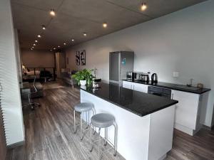 a kitchen with a counter and stools in a room at Waterkloof Nature Reserve Studio Apartment in Pretoria