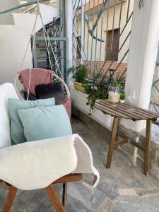 a porch with a chair and a table at Family friendly, cozy house in Athens in Piraeus