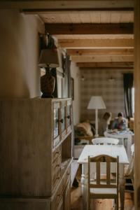 a living room with a table and a dining room at Na miły Bug Guesthouse by Bug river 