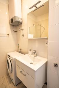 a bathroom with a sink and a washing machine at Valeria Louis perfect getaway - great location Split city center in Split