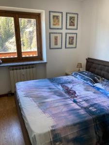 a bedroom with a large bed with a window at appartamento valtournenche il nido in Valtournenche