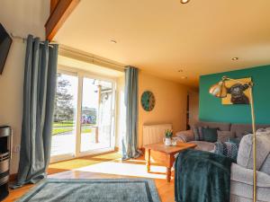 a living room with a couch and a window at Barcud Cottage in Carmarthen