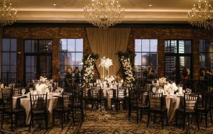 a banquet hall with tables and chairs and chandeliers at Hotel ZaZa Austin in Austin