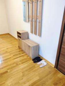 a pair of flip flops on the floor in a room at Apartment luxury Ub in Ub