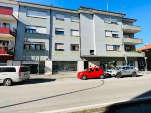 two cars parked in front of a building at Private room Thalia Apartments Mestre in Mestre