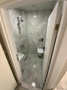 a bathroom with a shower and a toilet at ATICI HOTEL in Antalya