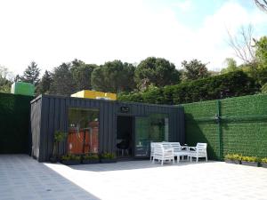 a black shed with a table and chairs on a patio at Mia Mia Suites in Istanbul