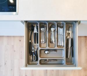a drawer filled with utensils on a counter at Design Apartment I Innenstadt I Küche I WIFI in Bingen am Rhein