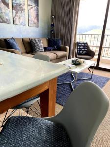 a living room with a couch and a table and chairs at The Whale Suite @Waikiki Banyan (1 Free Parking) in Honolulu