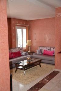 a living room with a couch and a coffee table at Très bel appartement au centre d'Agadir, in Agadir