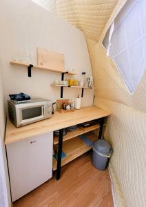 a tiny kitchen with a desk in a tiny house at Nomad Glamping in Šipovo