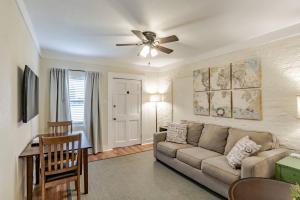 a living room with a couch and a ceiling fan at The Flats on Florida St - Super Comfy 2-Bedroom Apartments in Mobile