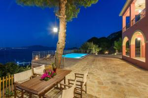 a wooden table and chairs next to a tree at Villa Eora in Keri