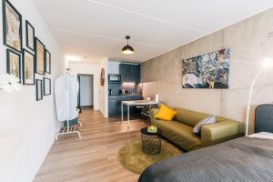 a living room with a couch and a table in a room at City-Living Appartement in Bielefeld