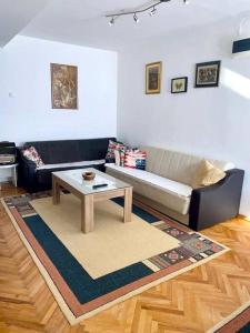 a living room with a couch and a coffee table at Rooftop terrace appartment in Skopje