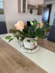 a vase filled with flowers sitting on a table at Rooftop terrace appartment in Skopje