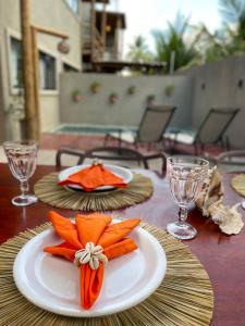 a wooden table with a plate with carrots on it at MAKAI Milagres in São Miguel dos Milagres