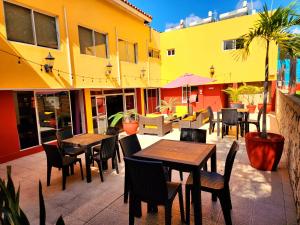 a patio with tables and chairs in a restaurant at Altamont West Hotel in Montego Bay