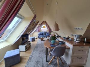 a kitchen and living room with an attic at Ferienwohnung Inselblick Norddeich mit Meerblick in Norden