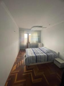 a bedroom with a bed and a wooden floor at Apartment to rent in Yerevan in Yerevan