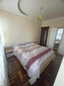 a bedroom with a bed and a chandelier at Apartment to rent in Yerevan in Yerevan