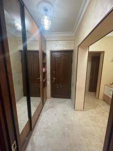 an empty hallway with two doors and a mirror at Apartment to rent in Yerevan in Yerevan