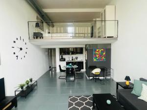 a living room with a couch and a table at Loft Confort in Alcalá de Henares