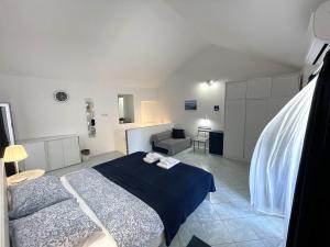 a bedroom with a bed and a desk and a chair at APARTMENT NUNA in Baška