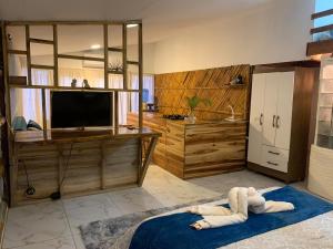 a person laying on a blue rug in a living room at ROOM LA ISLA in Ayampe