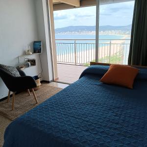 a bedroom with a bed and a view of the ocean at Davant Del Mar in Palamós