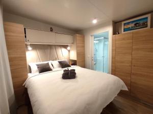 - une chambre dotée d'un grand lit blanc avec un sac à dos dans l'établissement Zen Zone Premium Mobile Home, à Drage