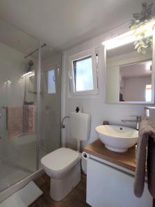 a bathroom with a sink and a toilet and a shower at Zen Zone Premium Mobile Home in Drage